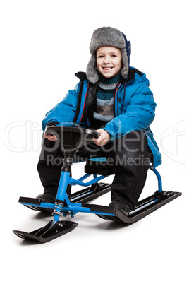 Child on snow scooter or snowmobile toy