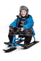 Child on snow scooter or snowmobile toy