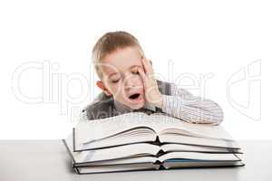 Child yawning on reading books