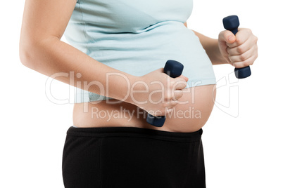 Pregnant woman holding fitness dumbbells