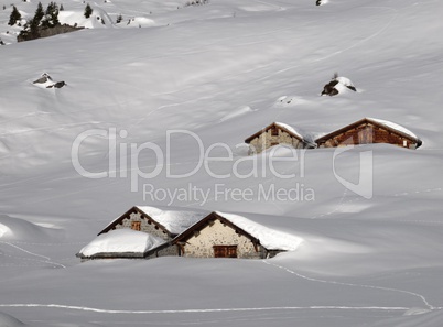 Huts covered by lots of snow