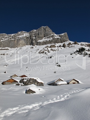 Snow covered huts and mountains near Braunwald