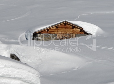 Timber hut, covered by lots of snow, Swiss Alps