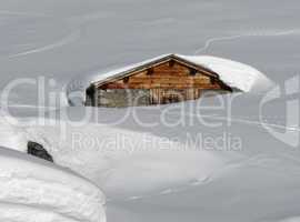 Timber hut, covered by lots of snow, Swiss Alps