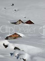 Huts nearly completely covered by snow, Swiss Alps