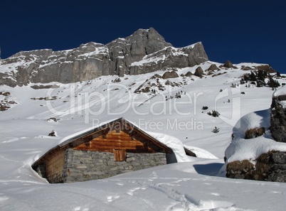 Timber hut and mountain, winter scene in Braunwald