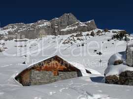 Timber hut and mountain, winter scene in Braunwald