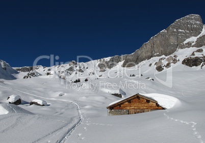 Plenty of snow in the alps, hut covered by snow