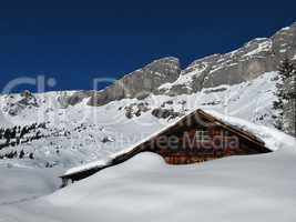 Old hut in the snow, mountains in Braunwald