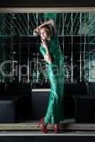 Young red woman in green dress - mirror room
