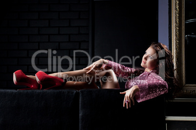 young beauty brunette woman relax on black sofa