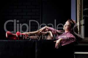 young beauty brunette woman relax on black sofa