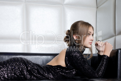 Beautiful brunette woman on sofa in nightclub