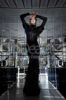 Beautiful woman in long black dress - mirror room