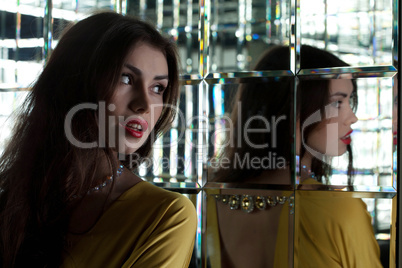 Pretty young woman near mirror