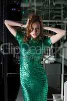 Young aggressive woman in green fashion dress