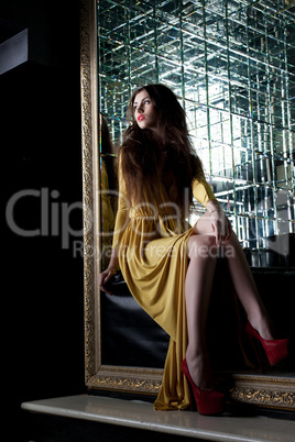 Brunette young woman in yellow long dress