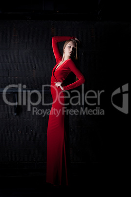 Young woman in red long dress - night club
