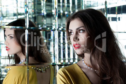 Beautiful brunette woman near mirror