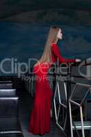 Beautiful woman posing in red long dress