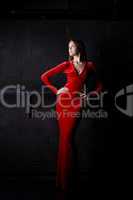 Beautiful woman posing in red long dress
