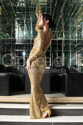 Brunette woman in gold dress