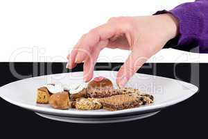 Hand reaching for cake plate