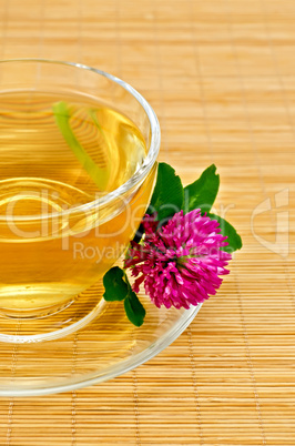 Herbal tea with clover on a bamboo mat