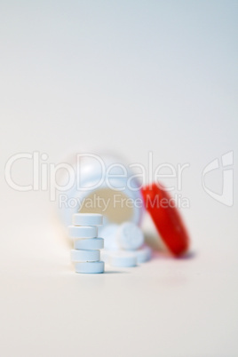 Pills in Front of Pill Bottle