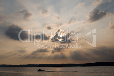 Fiery sunset over lake - with boat