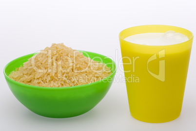 Rice in green bowl and milk in yell