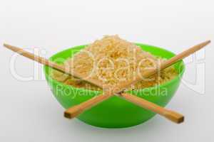Rice and chopsticks in green bowl