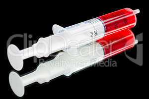 Syringe filled with 15 ml red medic