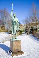 Statue in snow covered park