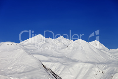 Winter mountains and blue sky