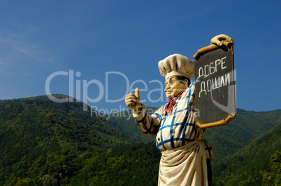 Chef mannequin holding tavern sign