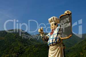 Chef mannequin holding tavern sign
