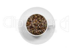 Ceramic cup and saucer filled with coffee beans