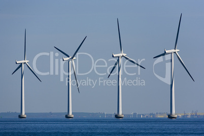 Four windmill generators in the sea