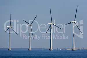 Four windmill generators in the sea