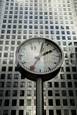 Clock against skyscraper