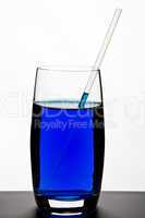 Blue drink in glass with straw