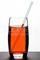Red drink in glass with straw