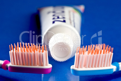 Close up of a blue and a red toothbrush