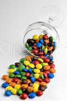 Overturned glass of M&M candies