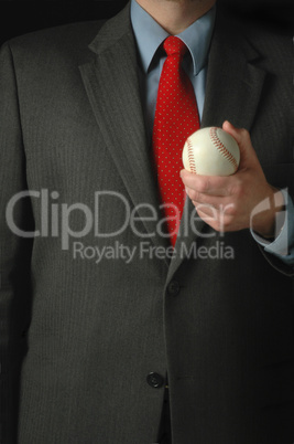 Sports executive in suit holding a