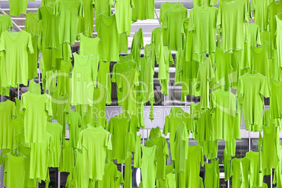 Green T-shirts hanging from the ceiling