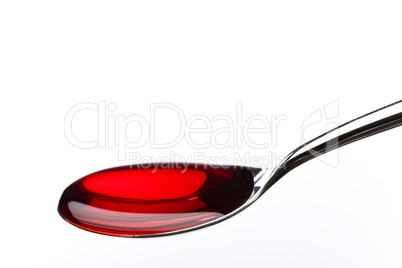 Spoon filled with red medicine