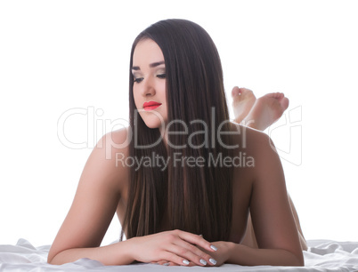 Beautiful woman with long hair lying on bed