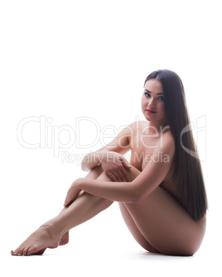 Pretty brunette woman posing nude isolated